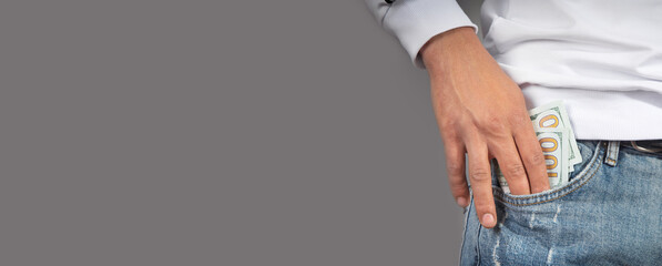 Man putting dollar into the pocket.