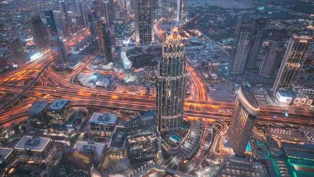 Dubai, UAE, United Arab Emirates. 4K View Form Viewpoint on Burj Khalifa time lapse. Day to Night timelapse. Change Transition To Night. City Traffic Under Khalifa Tower.