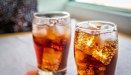 Refreshing Bubbly Soda Pop with Ice Cubes. Cold soda iced drink in a glasses - Selective focus,...