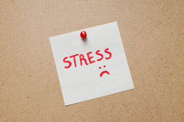 Paper with word Stress on beige background