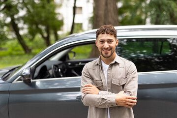 Attractive man standing next to his car and about to get in