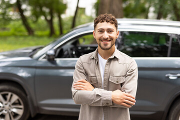 Attractive man standing next to his car and about to get in