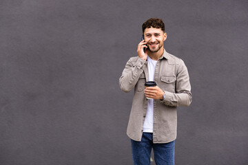 Young man talk on phone and walk on street