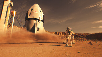 Two astronauts in spacesuits stand, watch spacecraft landing on Mars surface. Manned space mission...