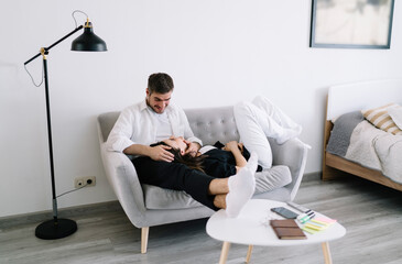 Happy couple relaxing on sofa