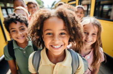 A group of kids of different nationalities from an elementary school take a group selfie photo.