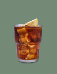 Iced tea, Cuba Libre or Long Island cocktail with cola, lemon and ice in a glass on green isolated background. The concept of a cold refreshing drink or lemonade.