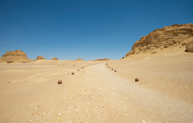 Fototapeta na wymiar Barren desert landscape in hot climate with mountain rock formation