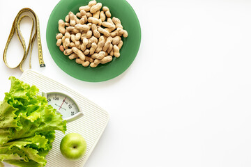 White floor weight scales and healthy food for diet menu, top view