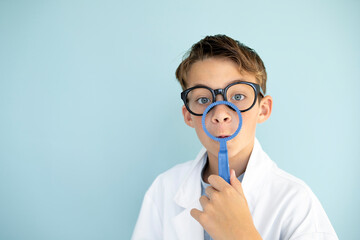 young mad scientist boy with white coat and blue ring