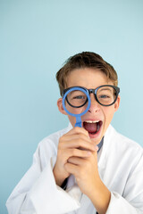 young mad scientist boy with white coat and blue ring