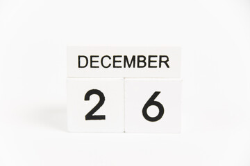 Wooden calendar with the date December 26 on a white background. The concept of preparing for the Christmas and New Year holidays.