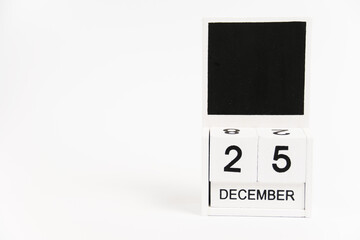 Wooden calendar with the date December 25 on a white background. The concept of preparing for the Christmas and New Year holidays.