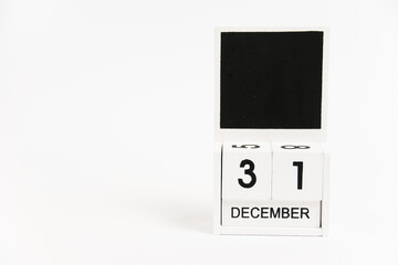 Wooden calendar with the date December 31 on a white background. The concept of preparing for the Christmas and New Year holidays.