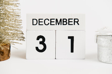 New Year, wooden calendar with the date December 31 and decor on a white background. The concept of preparing for the Christmas and New Year holidays.