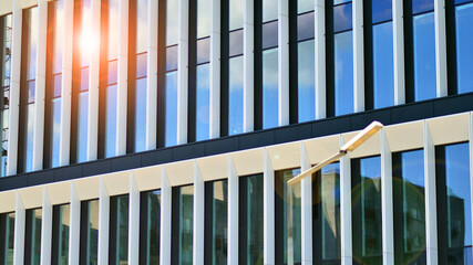 Glass modern building with blue sky background. View and architecture details. Urban abstract -...