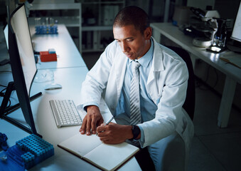 Doctor, writing notes and night in laboratory for medical research and study for healthcare report....