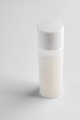 Transparent cosmetic bottle on white background. Healthy modern skin care beauty products. Mockup package of toner or lotion for healty skin. Cleanser or micellar water