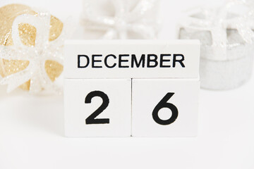 Boxing Day, wooden calendar with the date December 26 and decor on a white background. The concept of preparing for the Christmas and New Year holidays.