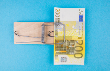 200 euros in a mousetrap on a blue background.