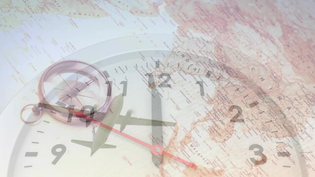Animation of clock and compass on map over low angle view of flying airplane against sky