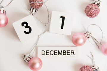New Year, wooden calendar with the date December 31 and decor on a white background. The concept of...