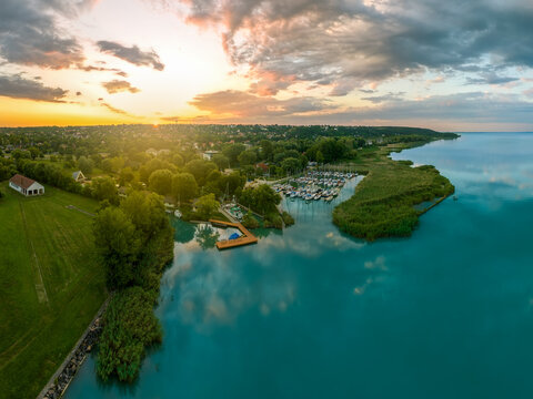 Aerial view about the north end  of lake Balaton in Hungary. This place is at Balatonfuzfo town. There is a small yacht harbor and fantastic sunrise light on the background.