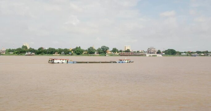 Sand barge is large, flat-bottomed boat that is used to transport sand over long distances on the Mekong river 