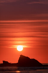 Currumbin Rock silhouette with red sunrise sky. Gold Coast, Australia