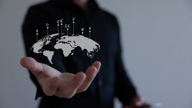 Global currency exchange concept, Hand holding world with virtual line effect and dollar yuan yen euro and pound sterling sign. - Powered by Adobe