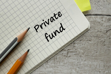 PRIVATE FUND two pencils and text on a notebook