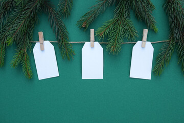 Christmas holiday composition having decoration labels. New year and xmas or anniversary with presents having tag on green background. Top view or flat lay, copy space.