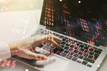 Multi exposure of abstract statistics data hologram interface with hands typing on computer keyboard on background, computing and analytics concept