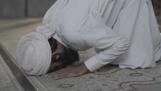 Peaceful Prayer: A Muslim Man Engaged in Salah at a Beautiful Mosque | Mosque Beauty: Witness the Elegance of Namaz (Salah) Performances