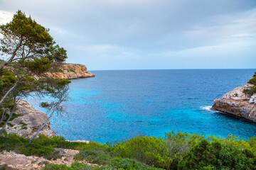 Beautiful sunset beach landscape, exotic tropical island nature, blue sea water, ocean waves, summer holidays vacation in Mallorca, Spain