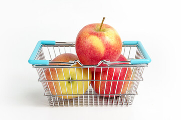 apples in a metal basket on a white background