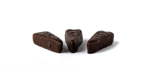 Depicted are three marmalade candies in chocolate on a white background.
