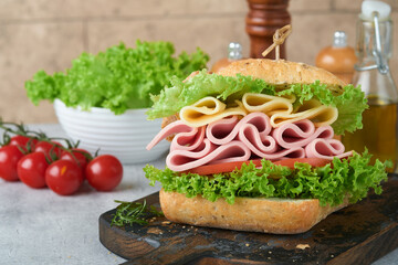 Sandwich. Tasty sandwich with ham or bacon, cheese, tomatoes, lettuce and grain bread. Delicious...