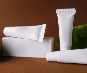 Moisturizer cream white tubes among natural green moss