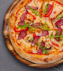 Fresh delicious pizza with three types of meat and sausage