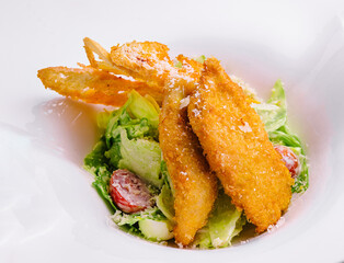 Chicken nuggets with vegetables salad on plate