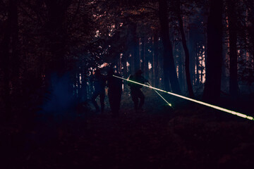 Soldiers squad in action on night mission using laser sight beam lights military team concept