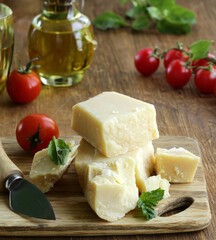 hard parmesan cheese block on wooden board