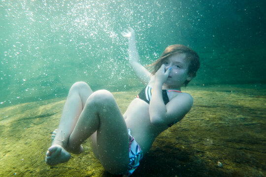 Underwater view of girl swimming in lake