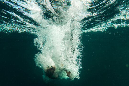Underwater view of woman swimming in lake