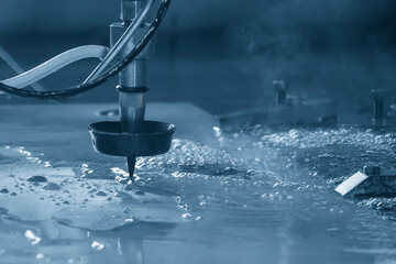 Close-up scene of multi-axis abrasive waterjet cutting machine cutting the aluminum plate.