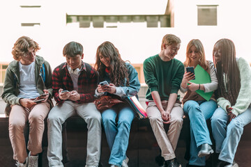 group of young people using mobile cellphone outdoor - youth addiction to technology