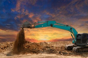 Crawler Excavator digging the soil,In the construction site on the sunset sky background ,With...
