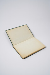 Old dark green notebook from 1950' on a white background.