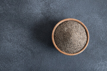Powder black pepper on black  background,top view